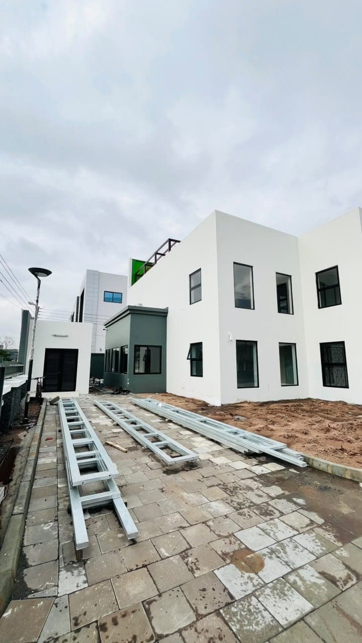 Modern commercial building exterior painted white and charcoal