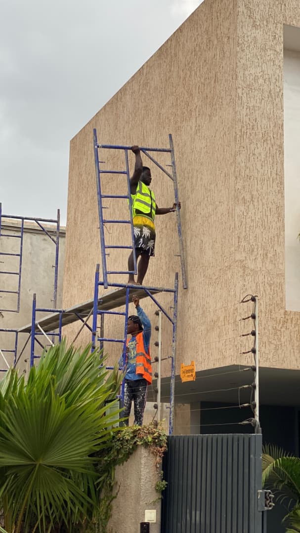 Frimsco painters applying a textured Graffiato finish to a tall exterior wall