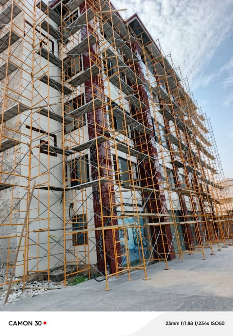 Multi-storey exterior painting project surrounded by scaffolding