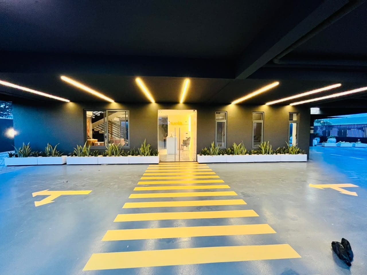 Wide view of completed yellow pedestrian crossing and traffic arrows